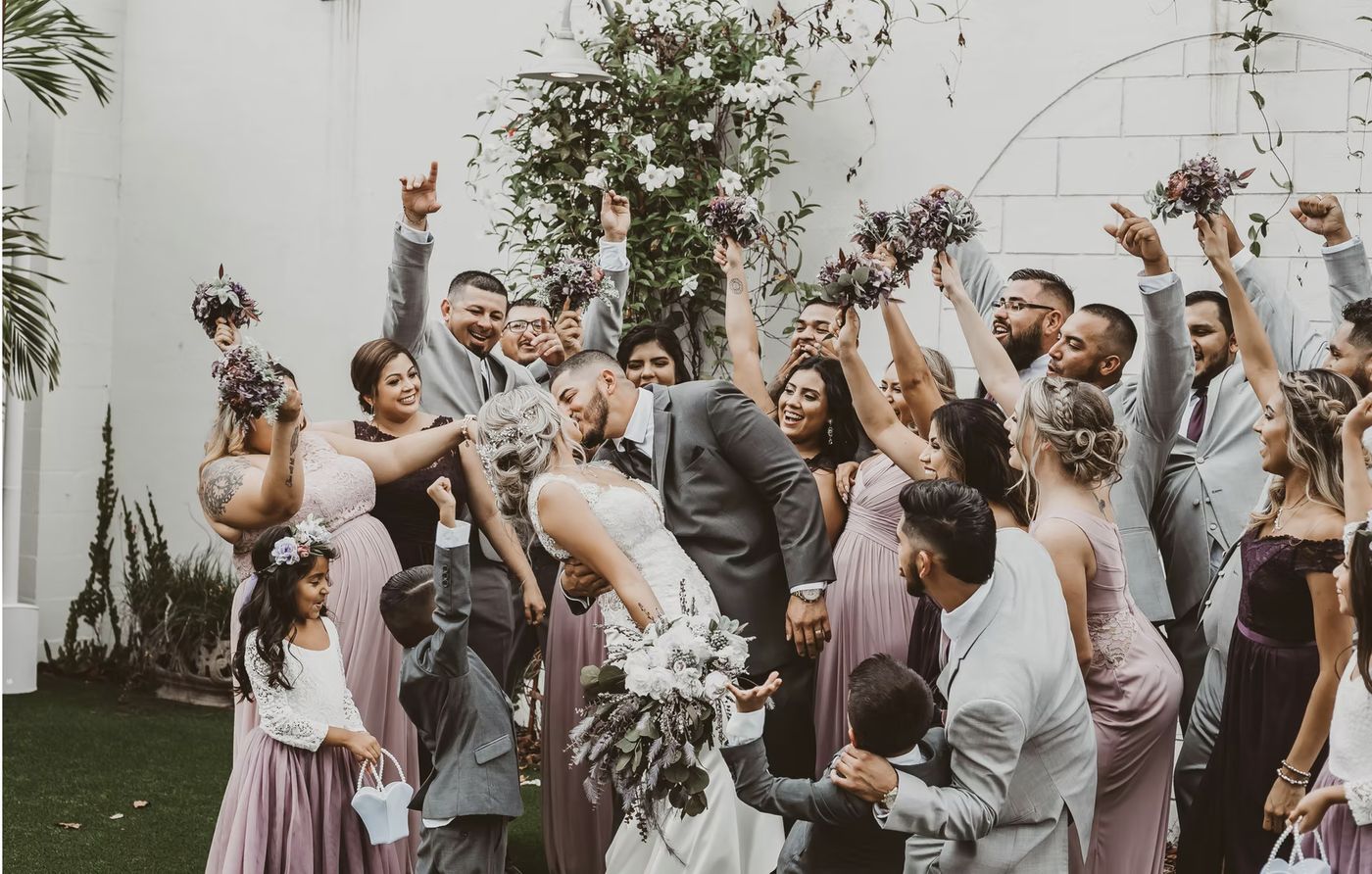 A wedding party gathered beneath the Florida oak in the walled garden at Venue 650 in Winter Haven