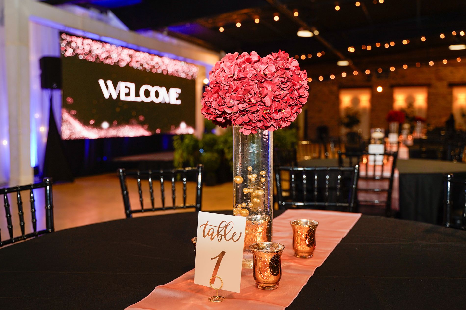 A corporate event set with a stage and presentation screen at Venue 650 in Winter Haven