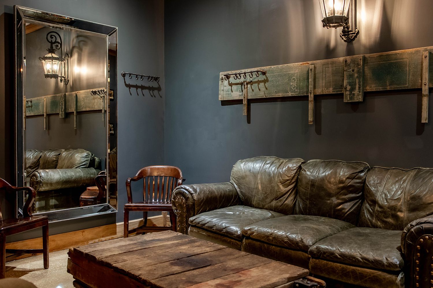 The grooms den at Venue 650 with leather seating against a dark panelled wall