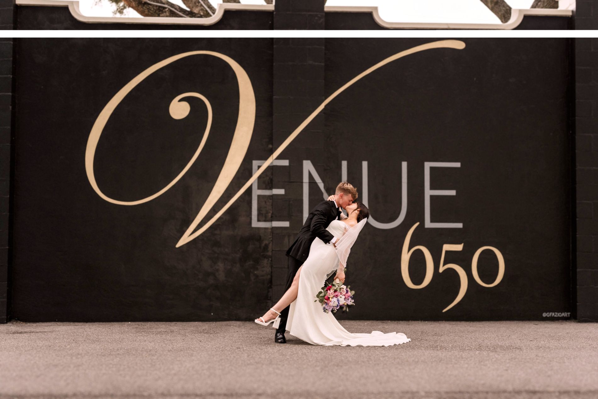 The Venue 650 lettering in gold on the black wall inside the hall